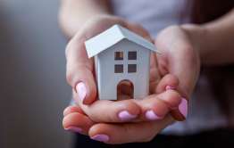 hands holding safe house